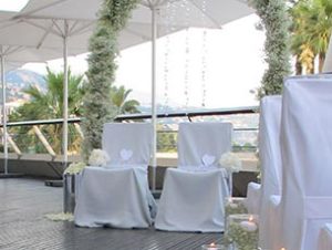 A terrace with a flower arch for a wedding