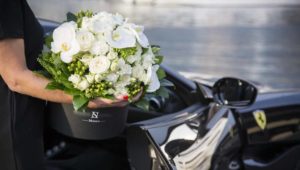 Box with black flowers in black Ferrari