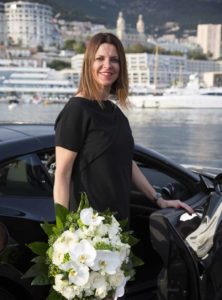 a pretty young woman receives a bouquet of flowers and orchids